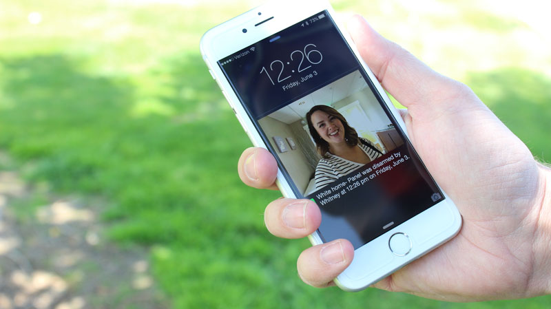 Smartphone receiving a notification from a home security camera