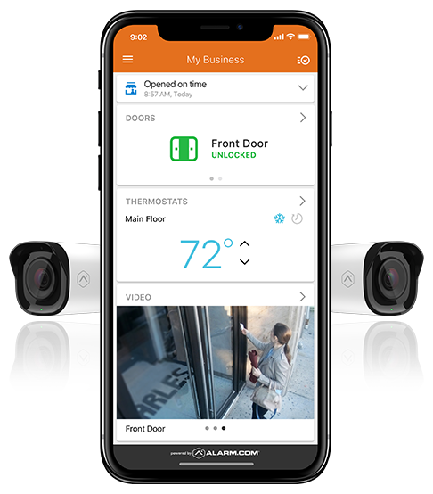 Mobile phone with Alarm.com interface showing live security camera feed with a security camera placed next to the mobile phone as an accent